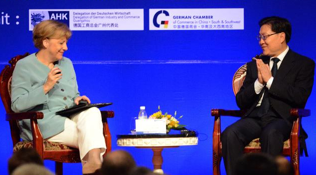 Angela Merkel (left) and Sichuan Provincial Party Secretary Wang Dongming attend the Urbanisation Forum, in Chengdu, southwest China's Sichuan province on July 6, 2014/AFP