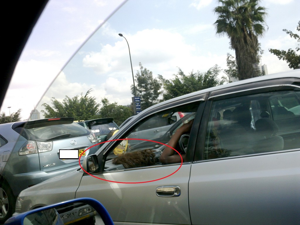 Kenya woman airs out weave on car dashboard (Susan Wong/2012)