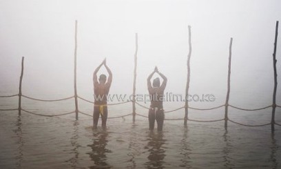 Devotees pray at the river Ganges during the Kumbh Mela celebration in Allahabad, India/AFP