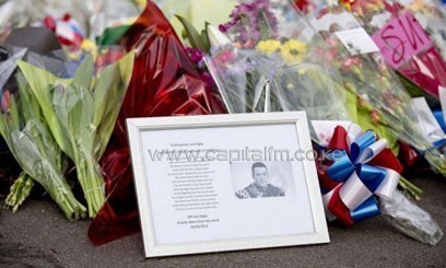 A framed photograph of murdered British soldier Lee Rigby lies amongst floral tributes outside Woolwich Barracks in London/AFP