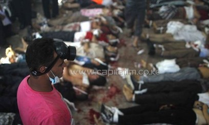 A man looks at bodies laid out in a make shift in Cairo, on August 14, 2013/AFP