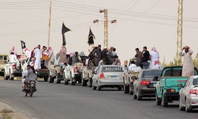 A funeral convoy carrying the bodies of four Egyptian militants, drives through the small Sinai village of Sheikh Zuweid on August 10, 2013/AFP