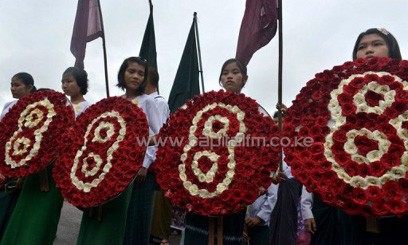 Students hold wreaths with the number eight, during a march to mark the 25th anniversary of the democratic uprising, also known also as "8888", in Yangon on August 8, 2013/AFP