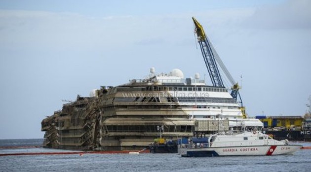 The wreckage of the Costa Concordia cruise ship was turned upright near Giglio island on September 17, 2013/AFP
