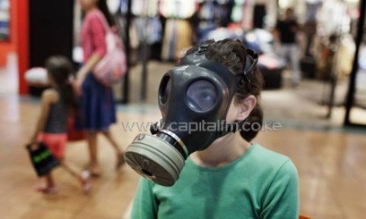 An Israeli girl tries on a gas mask at a distribution center in a shopping centre in Mevaseret Zion on the outskirts of Jerusalem on July 25, 2012/AFP