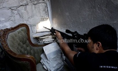 A Syrian rebel sniper shoots at forces loyal to Syrian President Bashar al-Assad/AFP