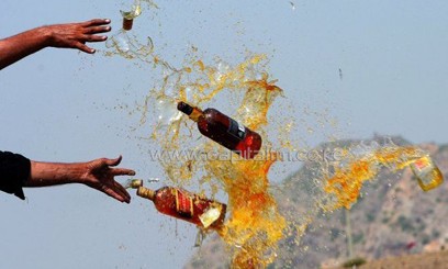 This file photo shows Pakistani officials destroying contraband alcohol, in the Shahkas area of the Jamrud Khyber Agency, on June 26, 2013. At least 18 people died and around two dozen others suffered serious health issues after partygoers at two separate events consumed toxic drinks in central Pakistan, officials said on Sunday/AFP