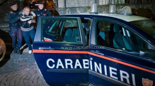 File photo shows Italian Carabinieri arresting a man in Naples on January 25, 2011, one of four suspects involved in the "Sayonara Bar massacre" in the city's Ponticelli district/AFP