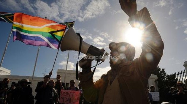 A group of people from the gay, lesbian and transgender community in South Africa demonstrate outside the Parliament in Cape Town, on May 19, 2012/AFP
