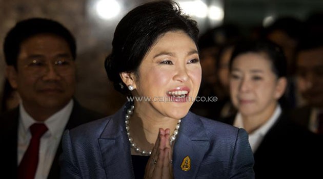 Thai Prime Minister Yingluck Shinawatra gives a traditional greeting as she arrives at the Constitutional Court in Bangkok on May 6, 2014/AFP