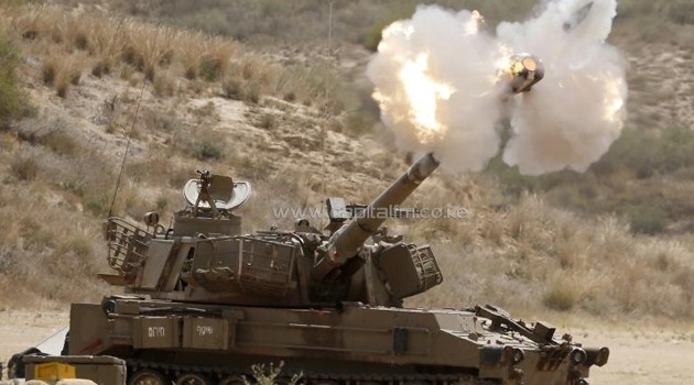 An Israeli howitzer fires a shell into the Gaza Strip, on July 18, 2014/AFP