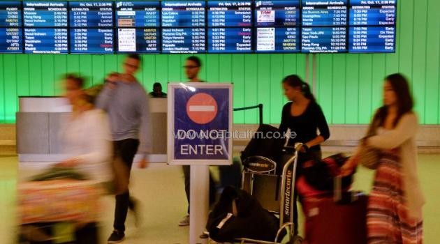 Passengers arrive at Los Angeles International Airport on October 17, 2014 as fear of the Ebola virus continues to grow/AFP