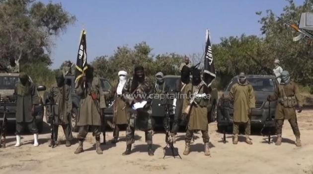 An image grab made on October 31, 2014 from a video obtained by AFP shows the leader of the Islamist extremist group Boko Haram Abubakar Shekau (C) delivering a speech/AFP