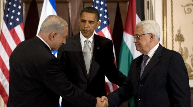 US President Barack Obama (centre) looks on as Israeli Prime Minister Benjamin Netanyahu (left) shakes hands with Palestinian leader Mahmoud Abbas before a 2009 meeting in New York/AFP