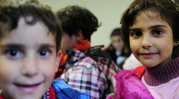 Young refugees play upon their arrrival in Celle, northern Germany, on September 8, 2015/AFP