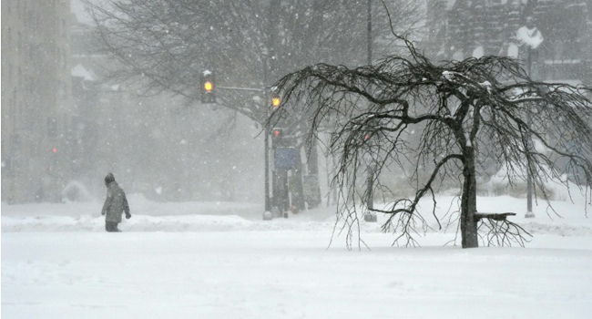 A man walks on snow covered Thomas Circle in Washington DC/AFP