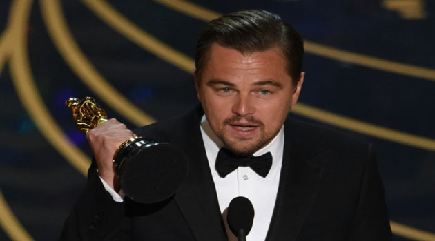 Actor Leonardo DiCaprio accepts the award for Best Actor in 'The Revenant' on stage at the 88th Oscars © AFP