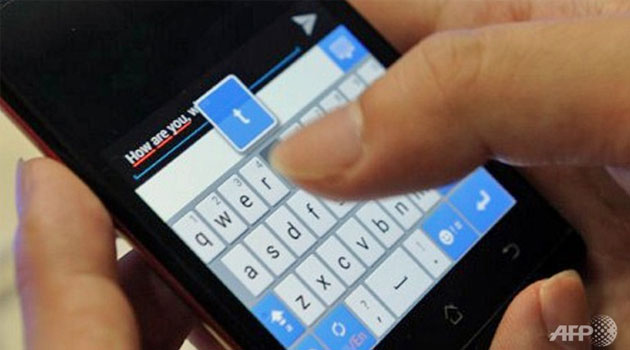 A user texting on a mobile phone/FILE