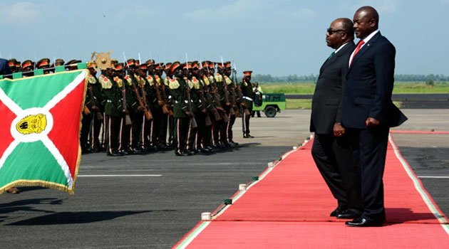 Burundi's President Pierre Nkurunziza (R) welcomes Gabon's president Ali Bongo Ondimba (L) upon his arrival on February 25, 2016 in Bujumbura/AFP