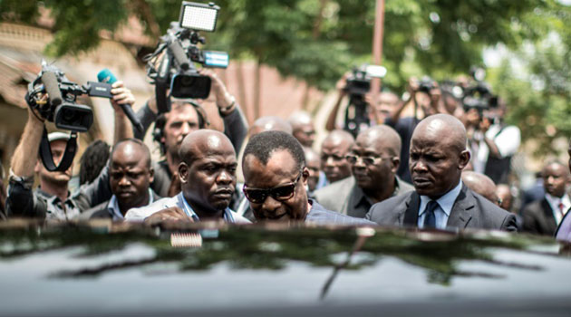 Incumbent Congolese President Denis Sassou Nguesso (C) leaves a polling station in Brazaville, after casting his ballot, on March 20, 2016, during the presidential election/AFP