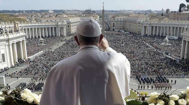 Pope Francis waving to the crowd from the central loggia of St Peters' basilica/AFP