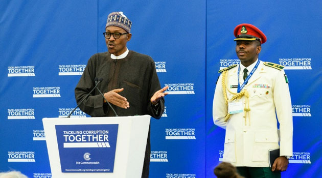 Nigerian President Muhammadu Buhari (L) addresses delegates at the start of a conference to tackle corruption at the Commonwealth Secretariat in London/AFP