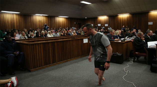 Paralympic gold medalist Oscar Pistorius prepares to walk across the courtroom without his prosthetic legs during the third day of his hearing at the Pretoria High Court for sentencing procedures in his murder trial in Pretoria on Jun 15, 2016/AFP
