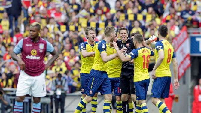Arsenal players celebrate after winning the English FA Cup final soccer match between Aston Villa and Arsenal at Wembley stadium in London, Saturday, May 30, 2015. Arsenal won the match 4-0.