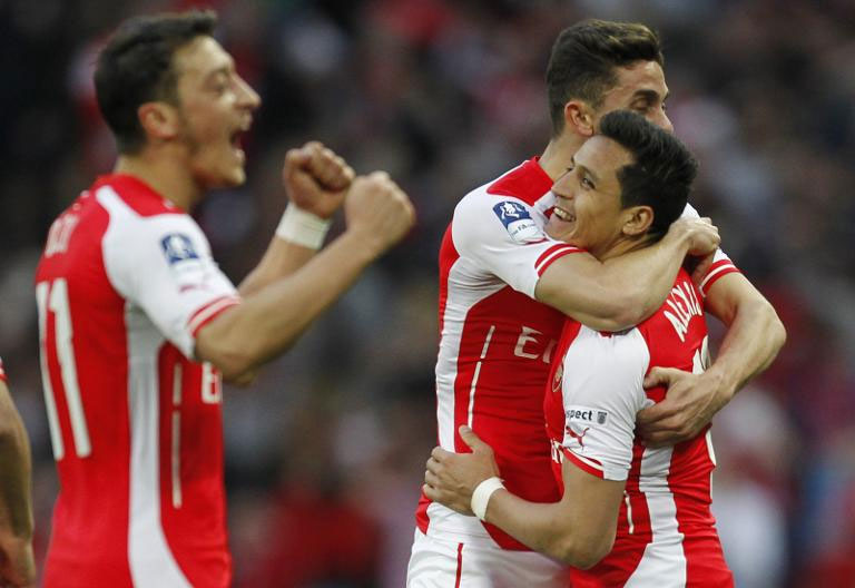Arsenal striker Alexis Sanchez (R) celebrates with teammate Gabriel after scoring his second goal during the FA Cup semi-final against Reading at Wembley stadium on April 18, 2015.