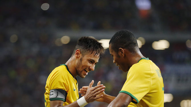 Brazil captain Neymar Jr. (left) celebrates scoring against Japan in an international friendly. PHOTO/FILE