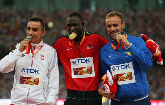 David Rudisha stands in the middle of the podium with his gold medal in Beijing on August 26, 2015. PHOTO/IAAF/Getty Images