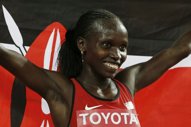 Kenya's Vivian Cheruiyot celebrates winning the women's 10,000m world title in Beijing on August 24, 2015. PHOTO/AFP