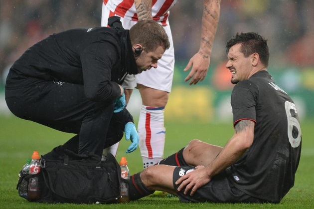 Liverpool's Dejan Lovren (R) receives treatment for an injury before being substituted during the League Cup semi-final first leg match against Stoke City at Britannia Stadium on January 5, 2016 (AFP Photo/Oli Scarff)