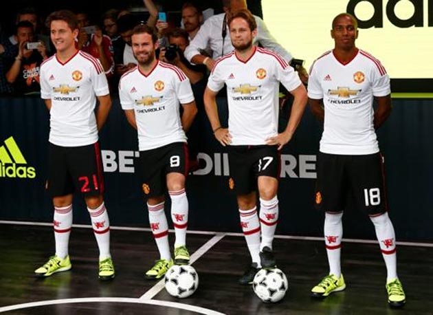 L-R: Manchester United's Ander Herrera, Juan Mata, Daley Blind and Ashley Young pose in the new Adidas away kit on August 11, 2015
