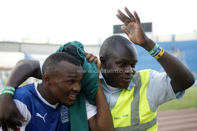 Gor Mahia forward Jacques Tuyisenge shielded by a steward after chaos erupted in their match against Tusker FC. PHOTO/Raymond Makhaya