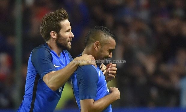 Dimitri Payet (r) is mobbed by Yohan Cabaye after his free-kick secured victory against Cameroon. PHOTO/AFP.