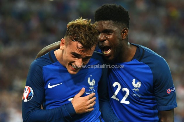 France's defender Samuel Umtiti (R) celebrates with forward Antoine Griezmann after he scored a penalty shot giving France the first goal of the match during the Euro 2016 semi-final against Germany, on July 7, 2016.PHOTO/AFP