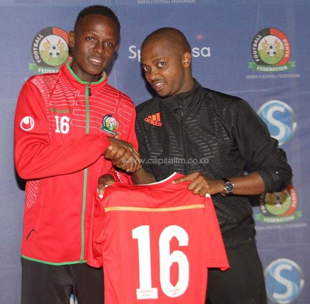 Harambee Stars under-17 captain Prince Korasoi Boit is handed over his jersey by FKF president Nick Mwendwa. PHOTO/COURTESY