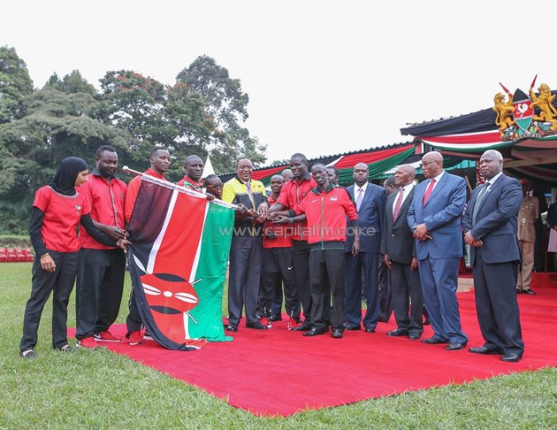 President Uhuru Kenyatta handing over the flag to Team Kenya.