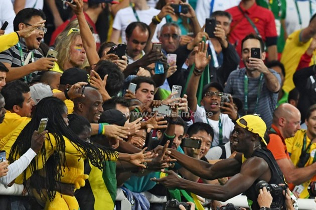 Jamaica's Usain Bolt celebrates with fans after winning the men's 100m final during the athletics event at the Rio 2016 Olympic Games.