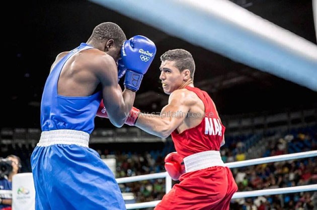Kenya's Rayton Okwiri (blue) guarding from Moroccan Rabii Mohamed (red) during the welterweight round of 16 bout at the Rio Olympics.