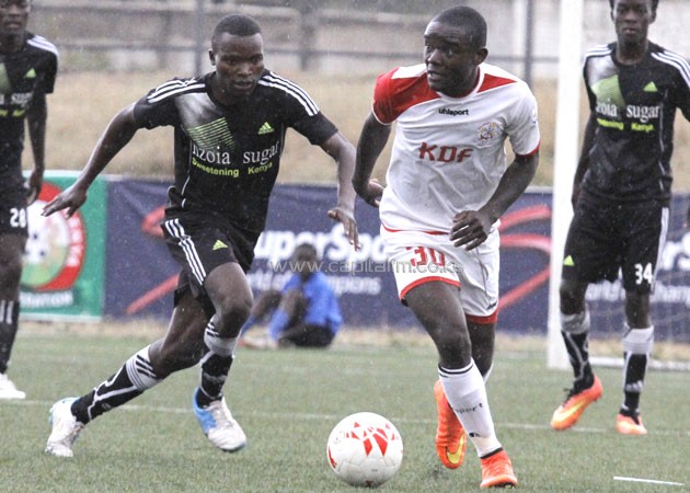Ulinzi Stars' forward John Mark Makwatta wehhels away from Nzoia United's Luke Namanda. PHOTO/COURTESY