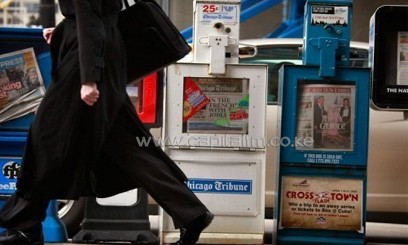 The Chicago Sun Times and Chicago Tribune newspapers are pictured on sale on April 2, 2009/AFP