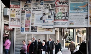 People queue to withdraw their savings at a Cypus Popular Bank in Athens/AFP