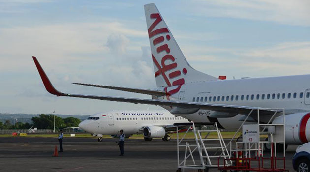 A file photo shows a Virgin Australia aircraft on the tarmac at Denpasar airport on the resort island of Bali, in April, 2014/AFP