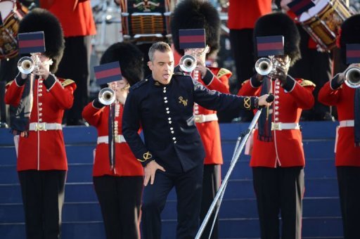 British singer-songwriter Robbie Williams performs on stage during the Queen's Diamond Jubilee Concert at Buckingham Palace in London. Queen Elizabeth II smiled as she took her place for a star-studded diamond jubilee concert Monday, despite her husband's sudden hospitalisation. (AFP Photo/Leon Neal)