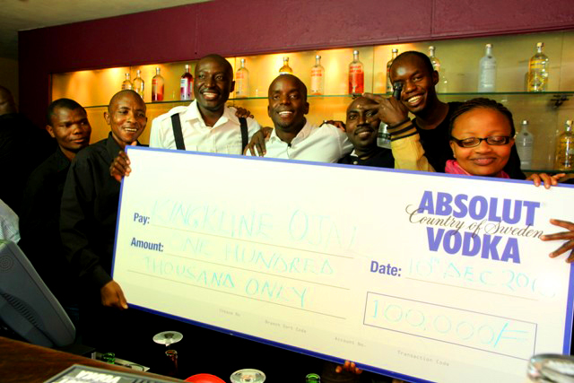 Kingkline Ojal celebrating his cheque with the Aqueous Bar team