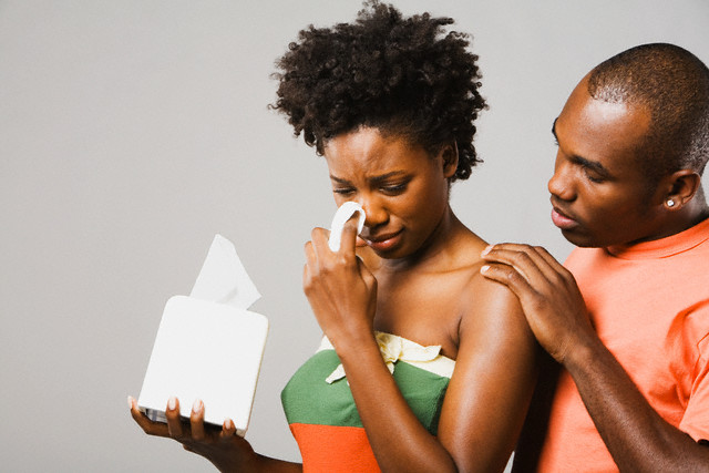 Hermosa Beach, California, USA --- African American man comforting crying girlfriend --- Image by © Hill Street Studios/Blend Images/Corbis