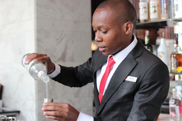 Dennis from Dusit preparing his cocktail with Monin flavoured syrup