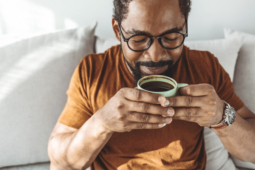 African American Man Smelling Cup of Coffee Web 1